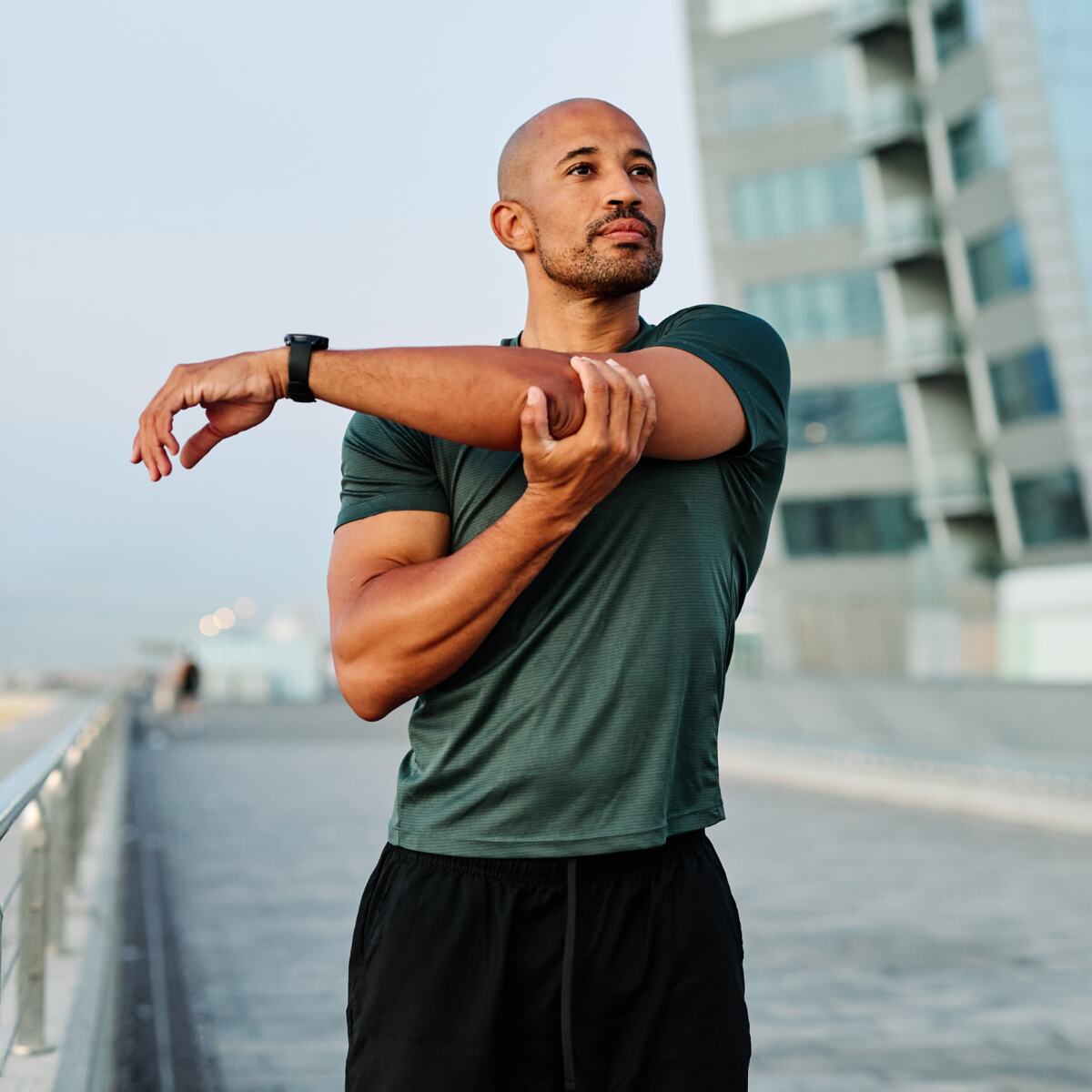 Athletic man stretching before a run outdoors