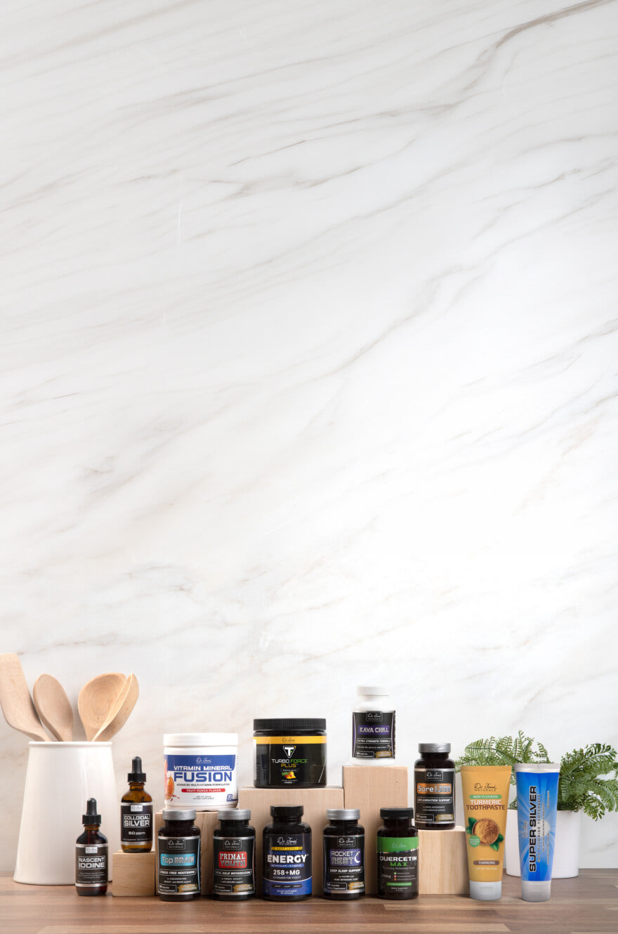 The Dr. Jones' Naturals supplement lineup — tinctures, capsules, powders and toothpaste — lined up on a wooden counter against a marble wall